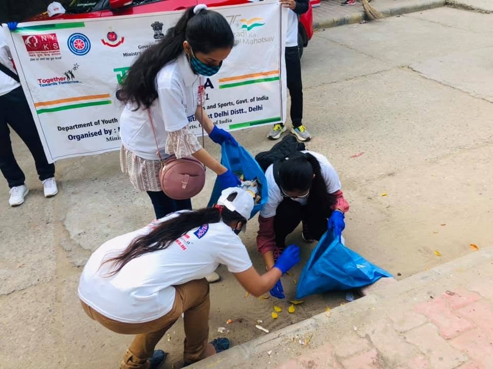 Volunteers collecting litter during a cleanliness drive